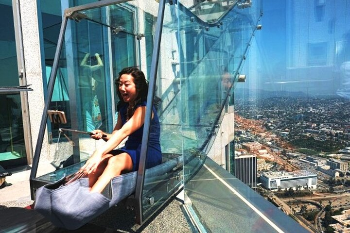 Experience the thrill of gliding above Dubai with breathtaking views of the Burj Khalifa and the cityscape all while seated in a transparent glass slide. Adventure awaits!